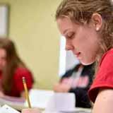 A BCYC Immersion student taking notes in class